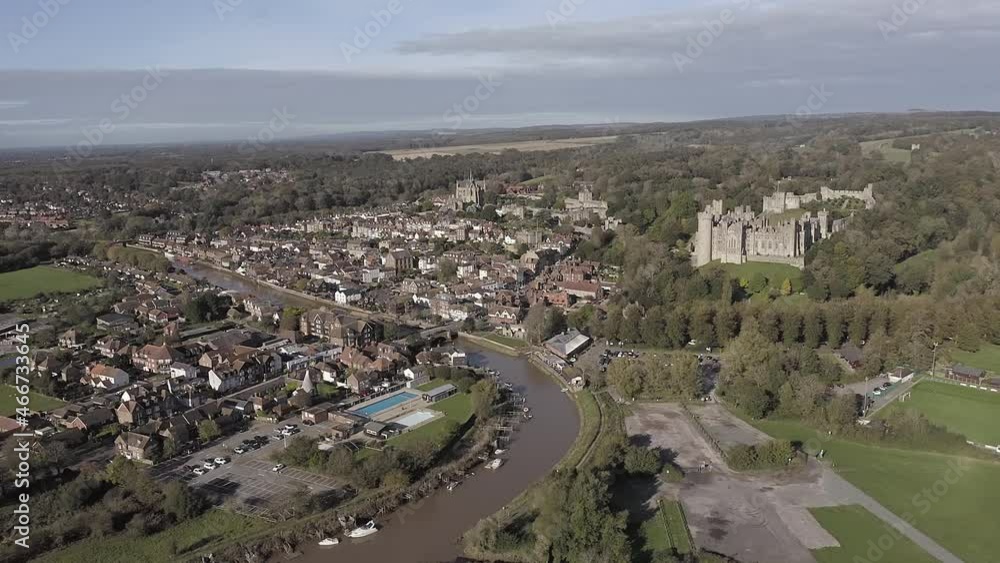 The old market town of Arundel with the Roman Catholic Cathedral and medieval Castle overlooking the town and the River Arun set in the foothills of the South Downs in West Sussex. Aerial footage. The old market town of Arundel with the Roman Catholic Cathedral and medieval Castle overlooking the town and the River Arun set in the foothills of the South Downs in West Sussex. Aerial footage.