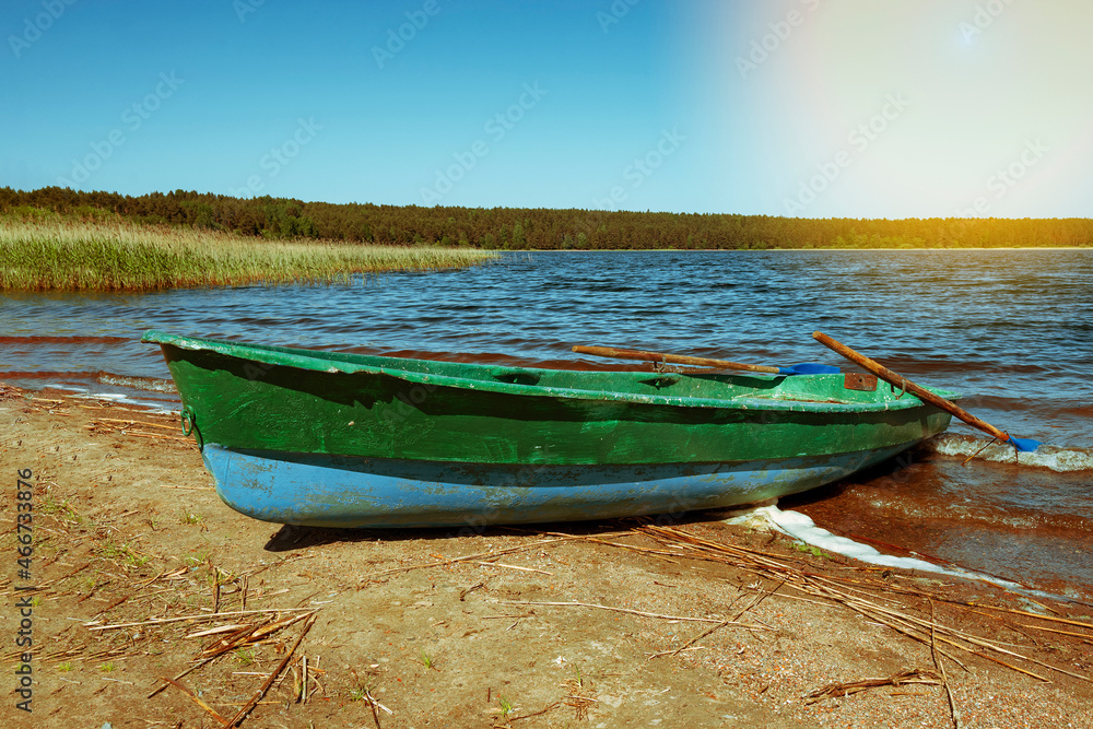 An old fishing boat on the coast . A boat with oars. A wooden fishing boat. An old fishing boat on the coast . A boat with oars. A wooden fishing boat.