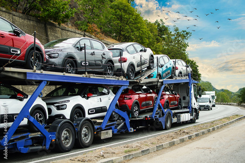 Hauling cars. Car carrier. Truck carrying cars. No logo or brand. © bogdan vacarciuc