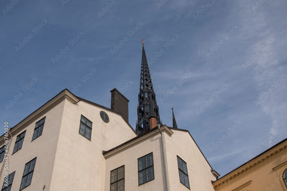 Tower of the church Riddarholmskyrkan and old houses on the island Riddarholmen a part of the old town Gamla Stan in Stockholm
