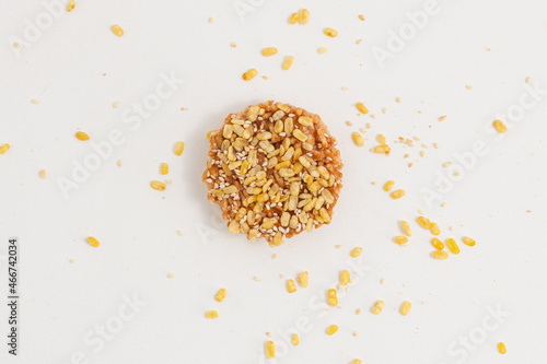 One piece of rice cracker mixed grains topping with Nuts, and White sesame seed on white background. Healthy Snack, Top view.