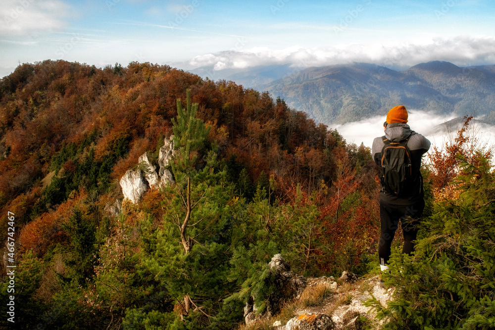 Photographer making photos in autumn mountains