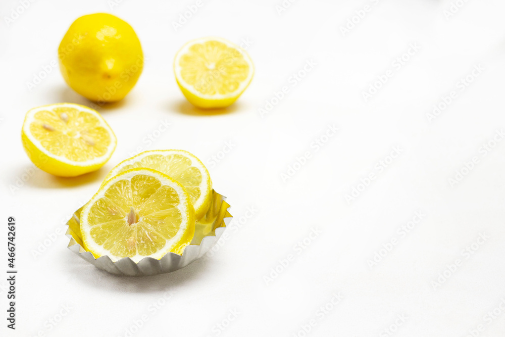Lemon wedges in small metal bowl