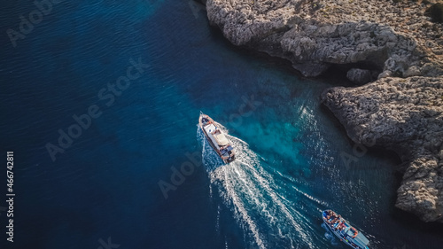 Top view from drone of speed boat in the blue water