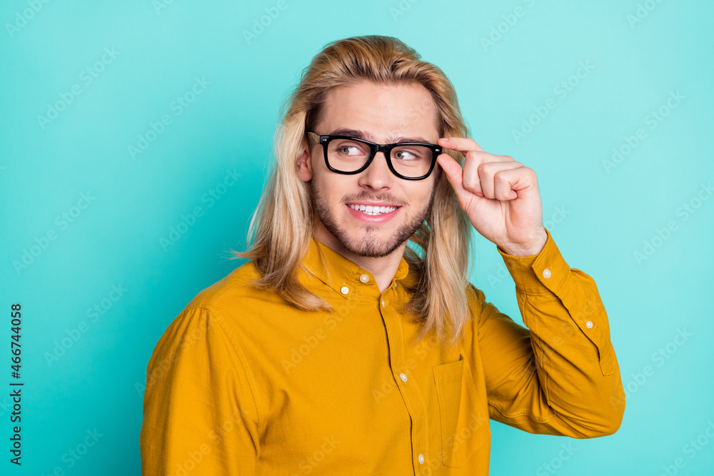 Profile side photo of young handsome man happy positive smile look empty space curious isolated over teal color background Profile side photo of young handsome man happy positive smile look empty space curious isolated over teal color background