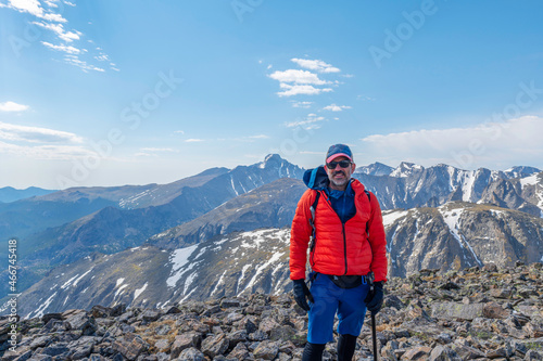 Hiker on the summit of Hallett Peak in Rocky Mountain National Park, Colorado, USA photo