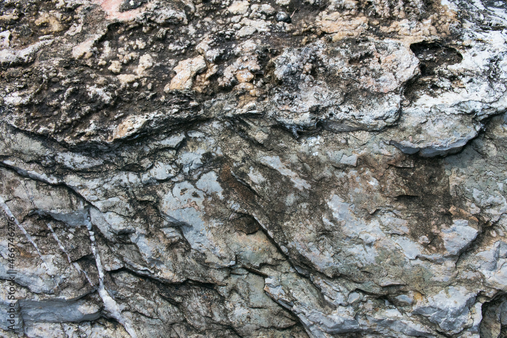 Huge Cracks And Layers. Coarse, Rough Gray Stone, Rock Texture Of Mountains Background Huge Cracks And Layers. Coarse, Rough Gray Stone, Rock Texture Of Mountains Background