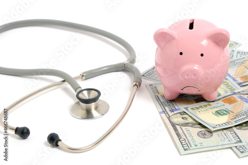 Stethoscope, bunch dollars and piggy bank on white background, concept expensive medicine.