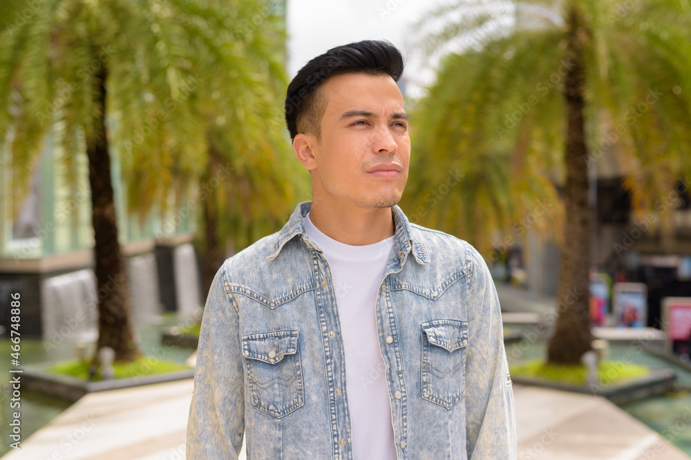 Portrait of handsome young man outdoors in city during summer thinking Portrait of handsome young man outdoors in city during summer thinking