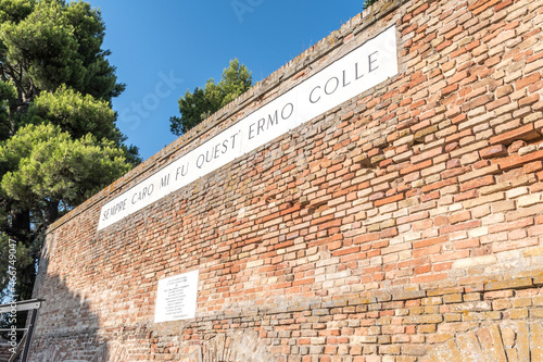 Recanati, Italy - August 13, 2021 - Famous wall of poet Giacomo Leopardi with text of his poem that means Always dear to me was this solitary hill