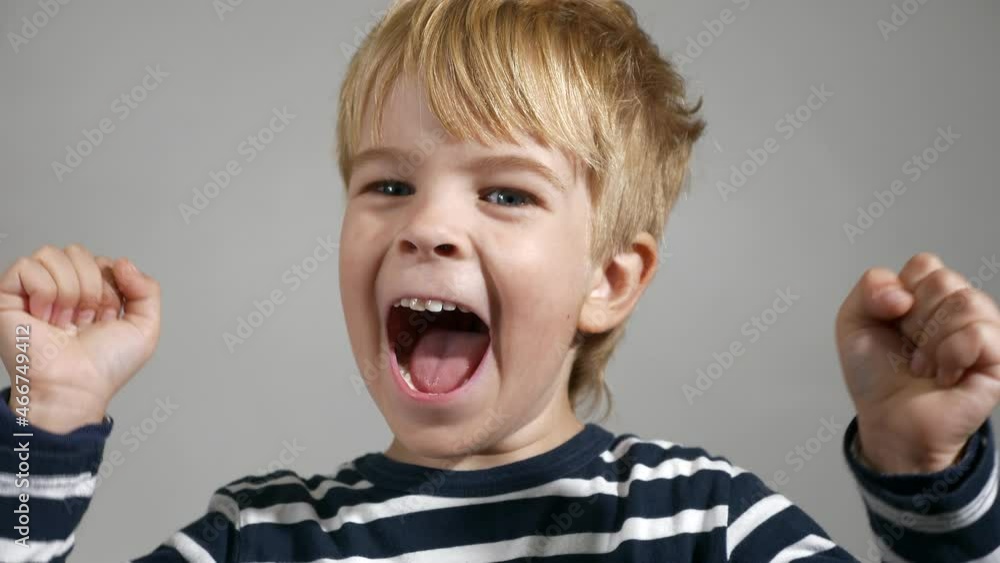Cheer Up Hands Gesture. Happy Child Face Emotions. Portrait Cute Little Boy. Glad Smiling Joyful Kid against White Wall Background. 2x Slow motion 60fps 4K Cheer Up Hands Gesture. Happy Child Face Emotions. Portrait Cute Little Boy. Glad Smiling Joyful Kid against White Wall Background. 2x Slow motion 60fps 4K