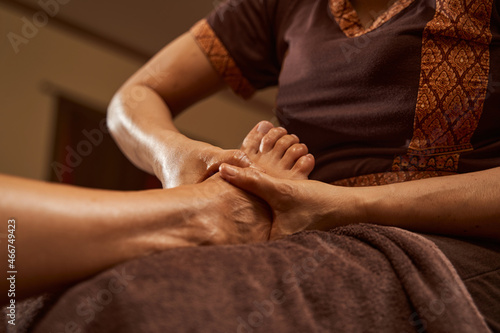 Licensed massage therapist massaging customer lower limb