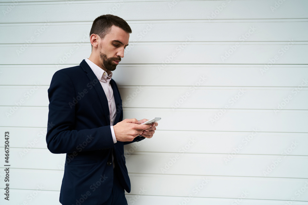 Caucasian businessman in smart casual wear chatting via mobile application near promotional background, male connecting to 4g wireless internet on cellular device for messaging about copy space text Caucasian businessman in smart casual wear chatting via mobile application near promotional background, male connecting to 4g wireless internet on cellular device for messaging about copy space text