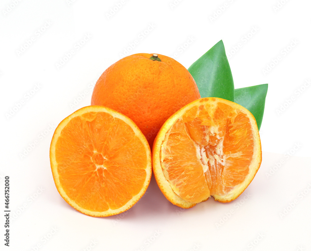 halved orange and green leaves isolated on white background halved orange and green leaves isolated on white background