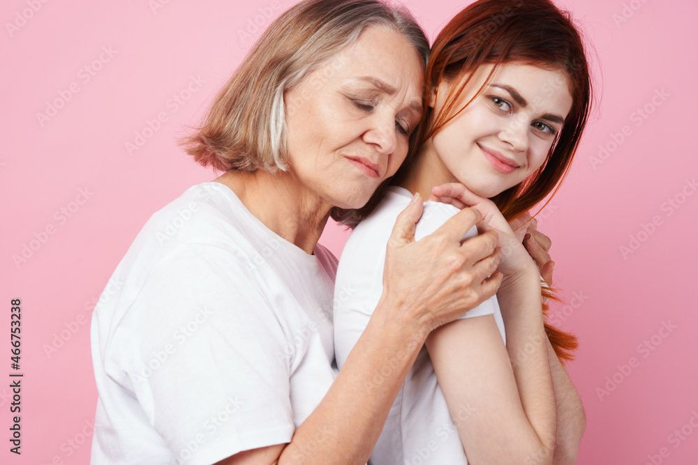 grandmother and granddaughter close communication together love pink background