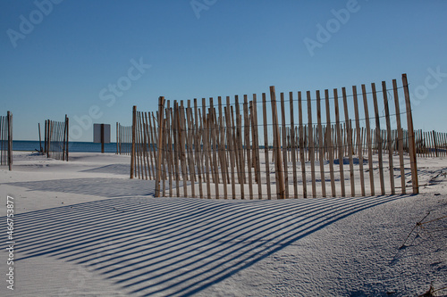white sandy beach with fences and blue sky's 