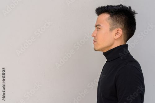 Fototapeta Naklejka Na Ścianę i Meble -  Profile view portrait of handsome young man against gray background