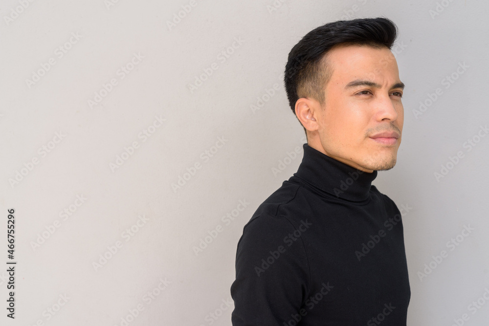 Portrait of handsome young man against gray background thinking Portrait of handsome young man against gray background thinking
