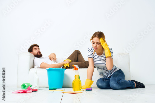 a young couple near the sofa cleaning supplies provision of services