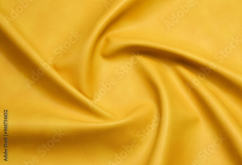 yellow artificial leather with waves and folds on PVC base