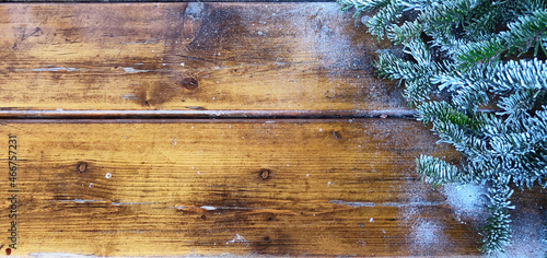 Winter background with fir branches on old boards.