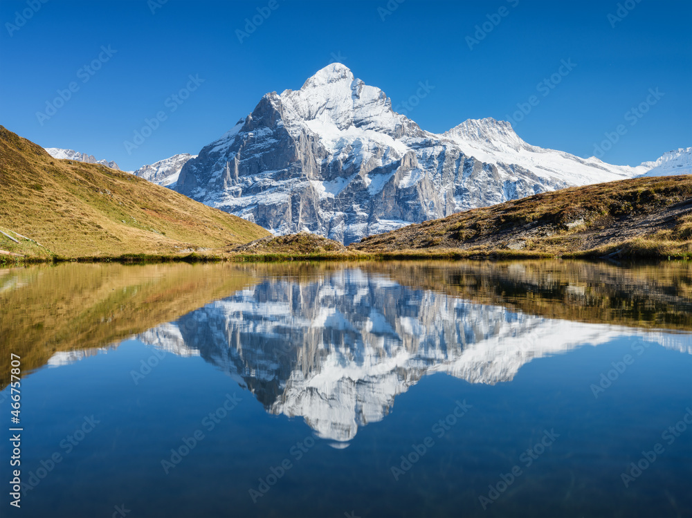 High mountains and reflection on the surface of the lake. Mountain valley with lake. Landscape in the highlands in the summertime. Photo in high resolution..