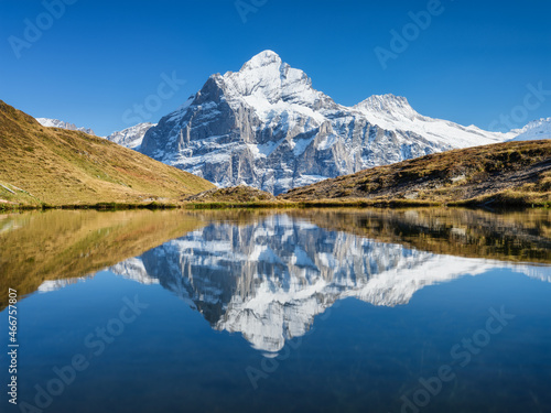 High mountains and reflection on the surface of the lake. Mountain valley with lake. Landscape in the highlands in the summertime. Photo in high resolution..