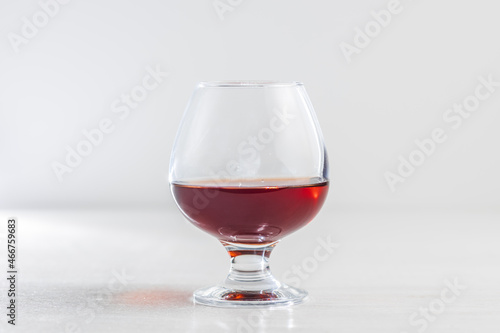 A glass of cognac on a white background