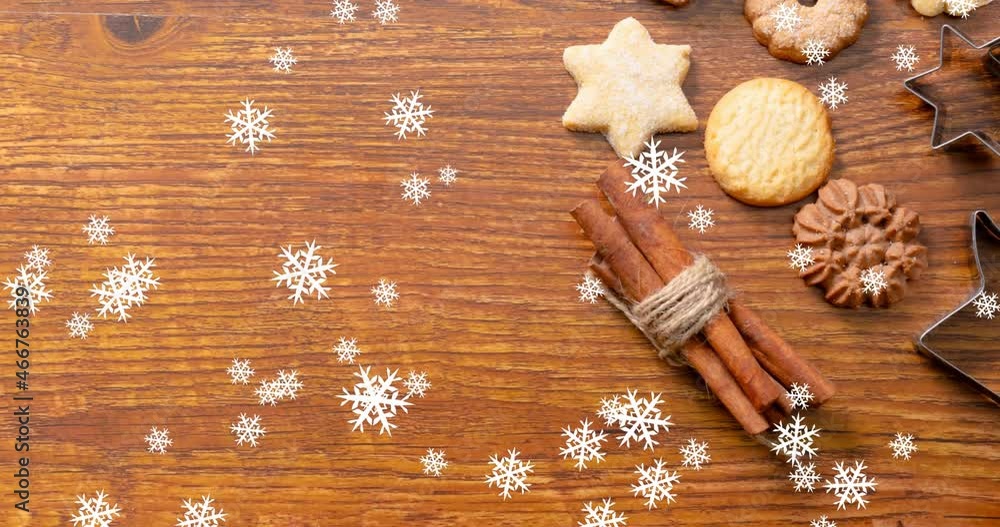 Animation of snow falling over christmas cookies on table Animation of snow falling over christmas cookies on table