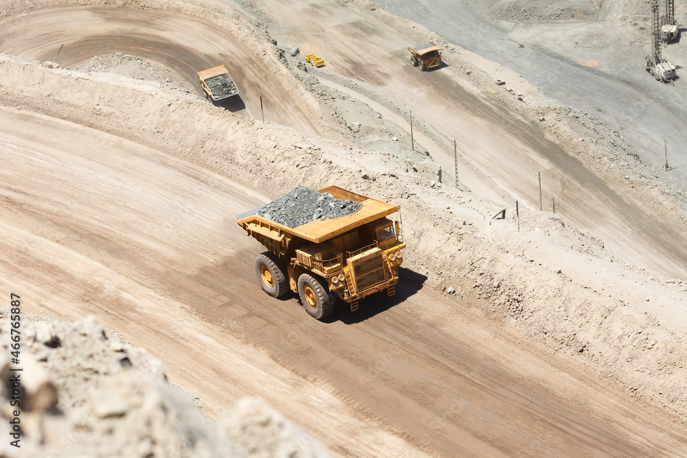Huge dump trucks loaded with mineral in a copper mine in Chile. Huge dump trucks loaded with mineral in a copper mine in Chile.