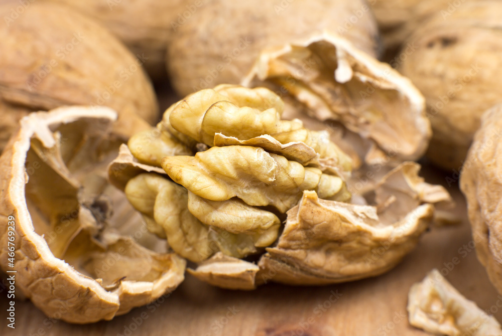 Crushed Walnut on the wood background. Close up. Crushed Walnut on the wood background. Close up.