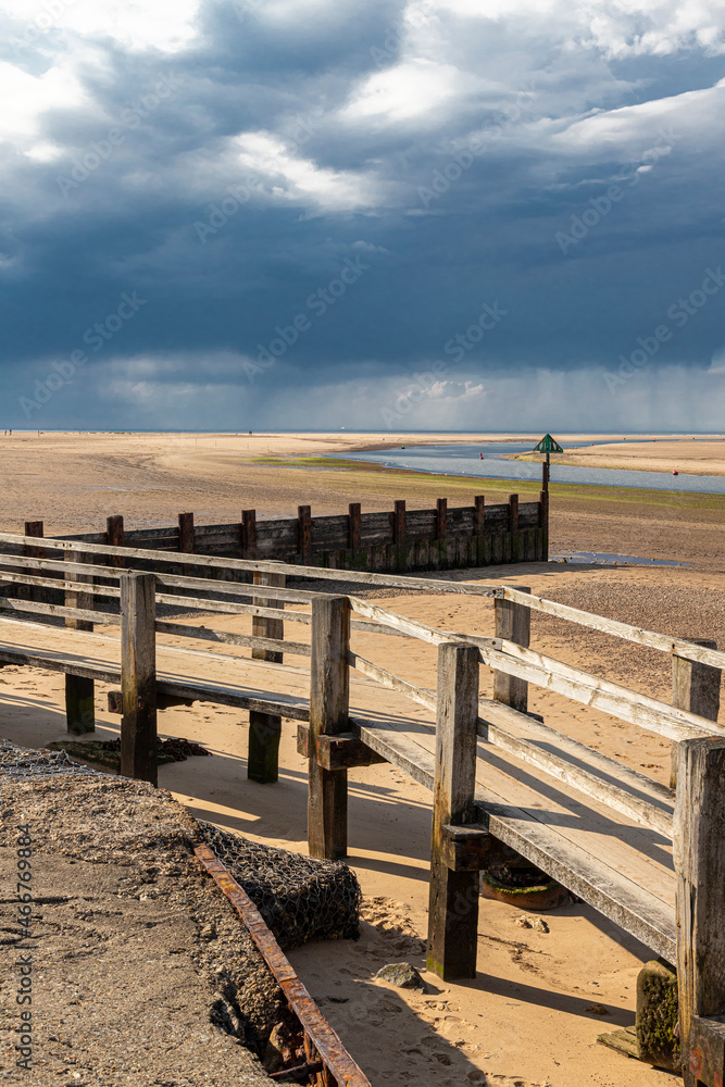 Obraz premium A rain storm over the sea on the beach at Wells next the Sea, Norfolk UK