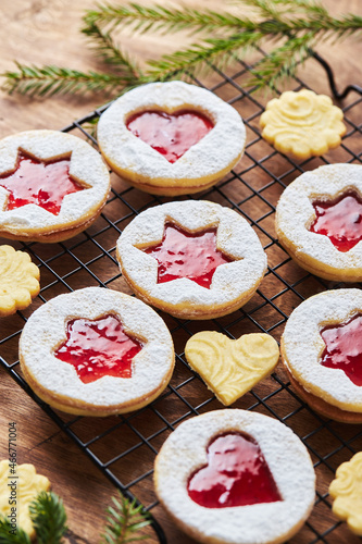 Classic Linzer Christmas Cookies with raspberry or strawberry jam on wooden table photo