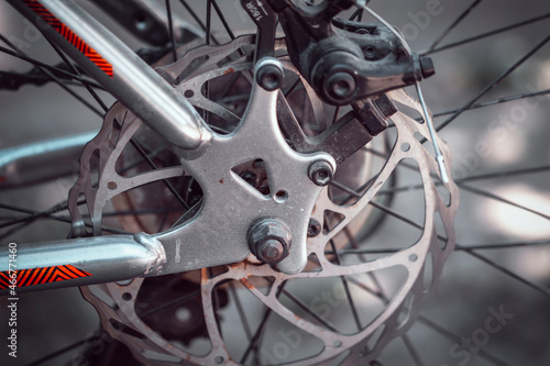 Bicycle elements in close-up. Individual parts of a sports bike are in focus. The vehicle parts are covered with dust