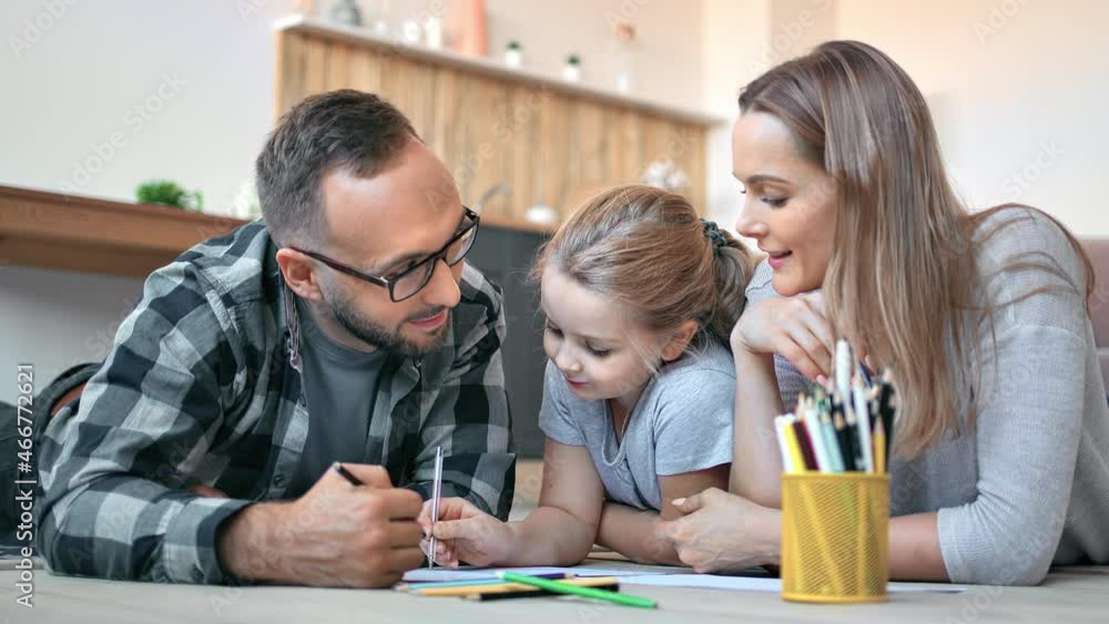 Happy family drawing paper picture together use multicolored pencil comfortable living room Happy family drawing paper picture together use multicolored pencil comfortable living room