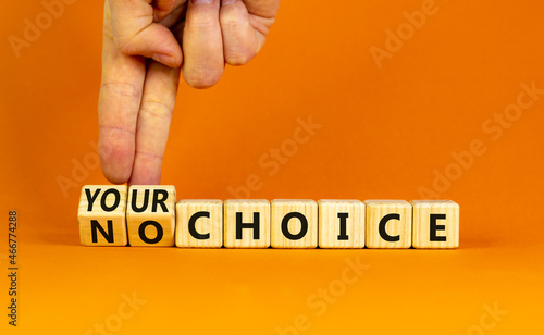 No or your choice symbol. Businessman turns wooden cubes and changes words 'no choice' to 'your choice'. Beautiful orange background, copy space. Business and no or your choice concept.