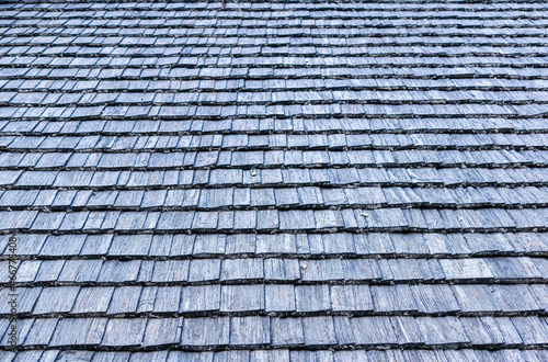 Closeup of the area of an old village roof made of wooden shingles.