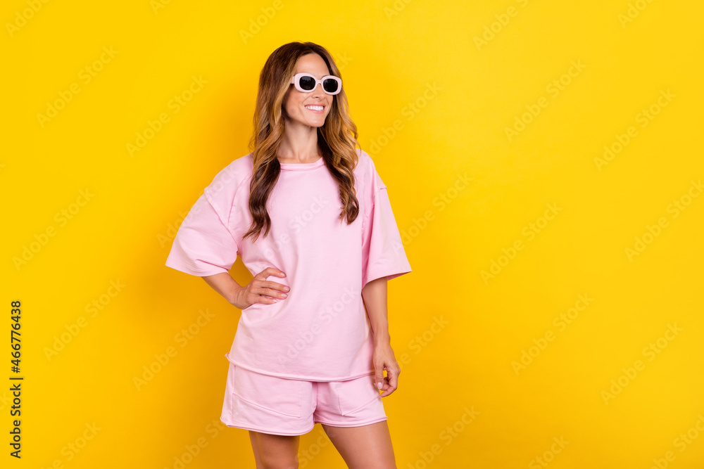 Photo of young attractive woman happy positive smile wear glasses isolated over yellow color background Photo of young attractive woman happy positive smile wear glasses isolated over yellow color background