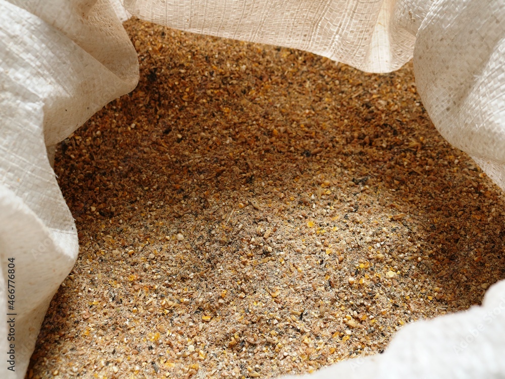 crushed compound feed for farm animals and poultry domans in an open