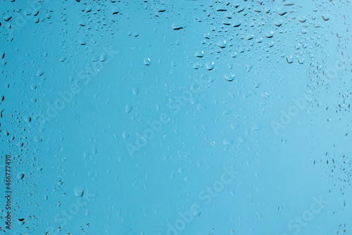 Blue backgrond with water drops. Wet glass.