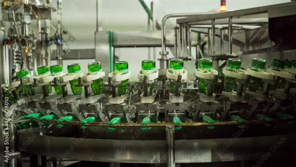 Glass bottles getting cleaned on a converyor belt Glass bottles getting cleaned on a converyor belt