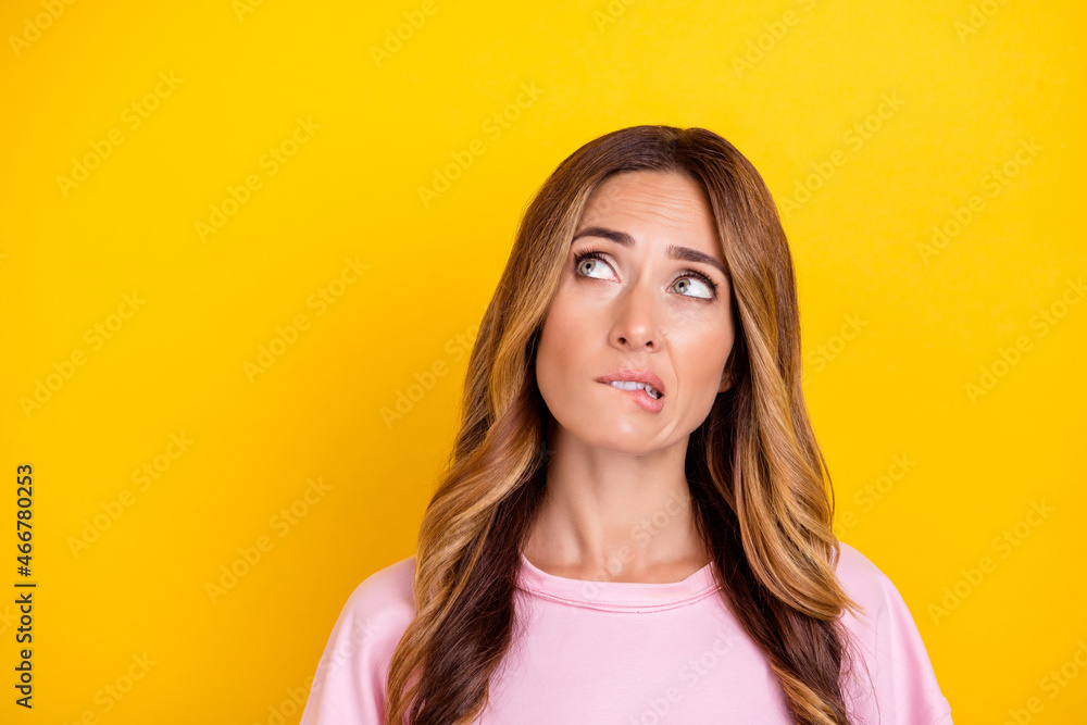 Photo of young attractive woman bite lips teeth worried nervous fail problem isolated over yellow color background Photo of young attractive woman bite lips teeth worried nervous fail problem isolated over yellow color background