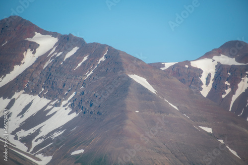 Landscape of snow covered mountains from fjord in North Iceland