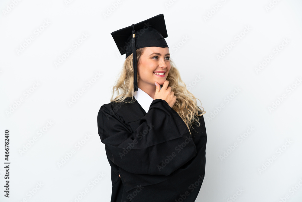 Young university graduate woman isolated on white background looking to the side and smiling Young university graduate woman isolated on white background looking to the side and smiling