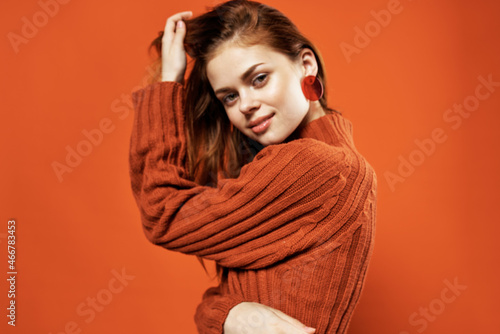 woman in red sweater fashion studio posing red background