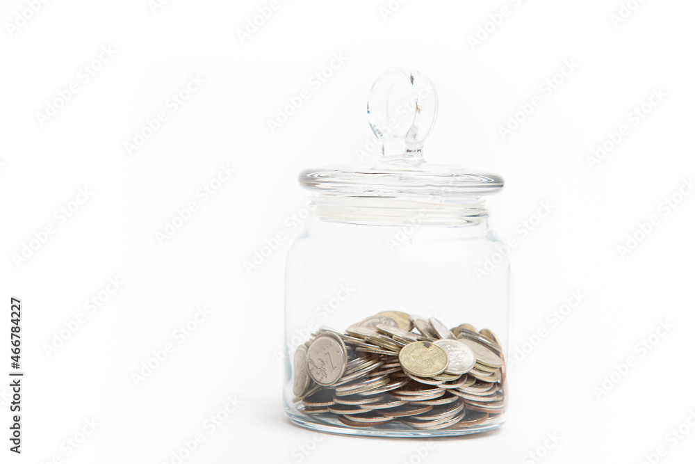 The coins in the bank are isolated on a white background . Business and finance. Lots of coins. Copy space. The coins in the bank are isolated on a white background . Business and finance. Lots of coins. Copy space.