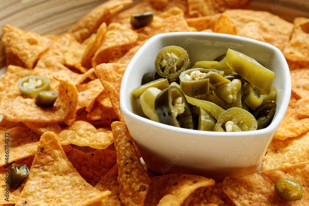 Nacho with chili pickles. Spicy peppers in bowl with corn chips. Nacho with chili pickles. Spicy peppers in bowl with corn chips.