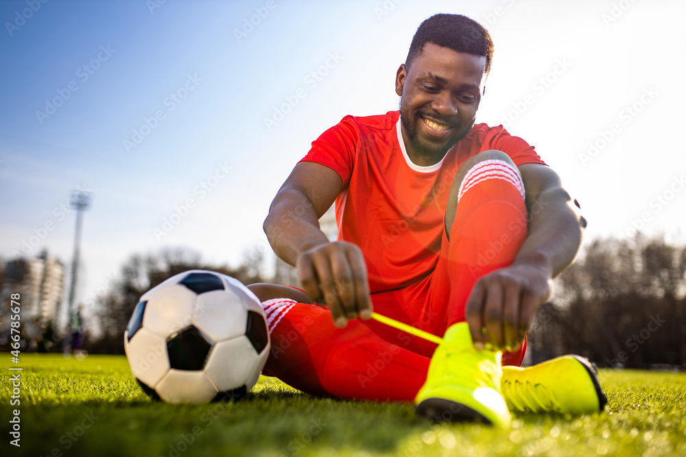 Fototapeta premium brazilian man goalkeeper catches the ball in the stadium during a football training
