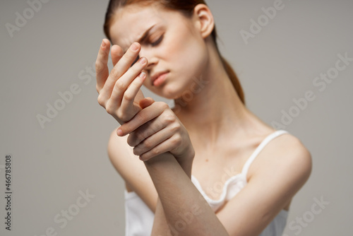 disgruntled woman holding on to the arm health problems joint studio treatment