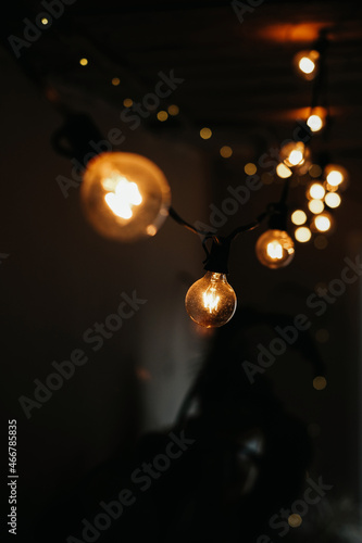 photo of a garland of light bulbs on a dark background. selective focus. christmas and new year concept 